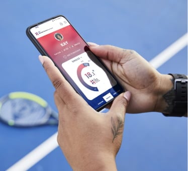 hands holding mobile phone displaying world tennis number website